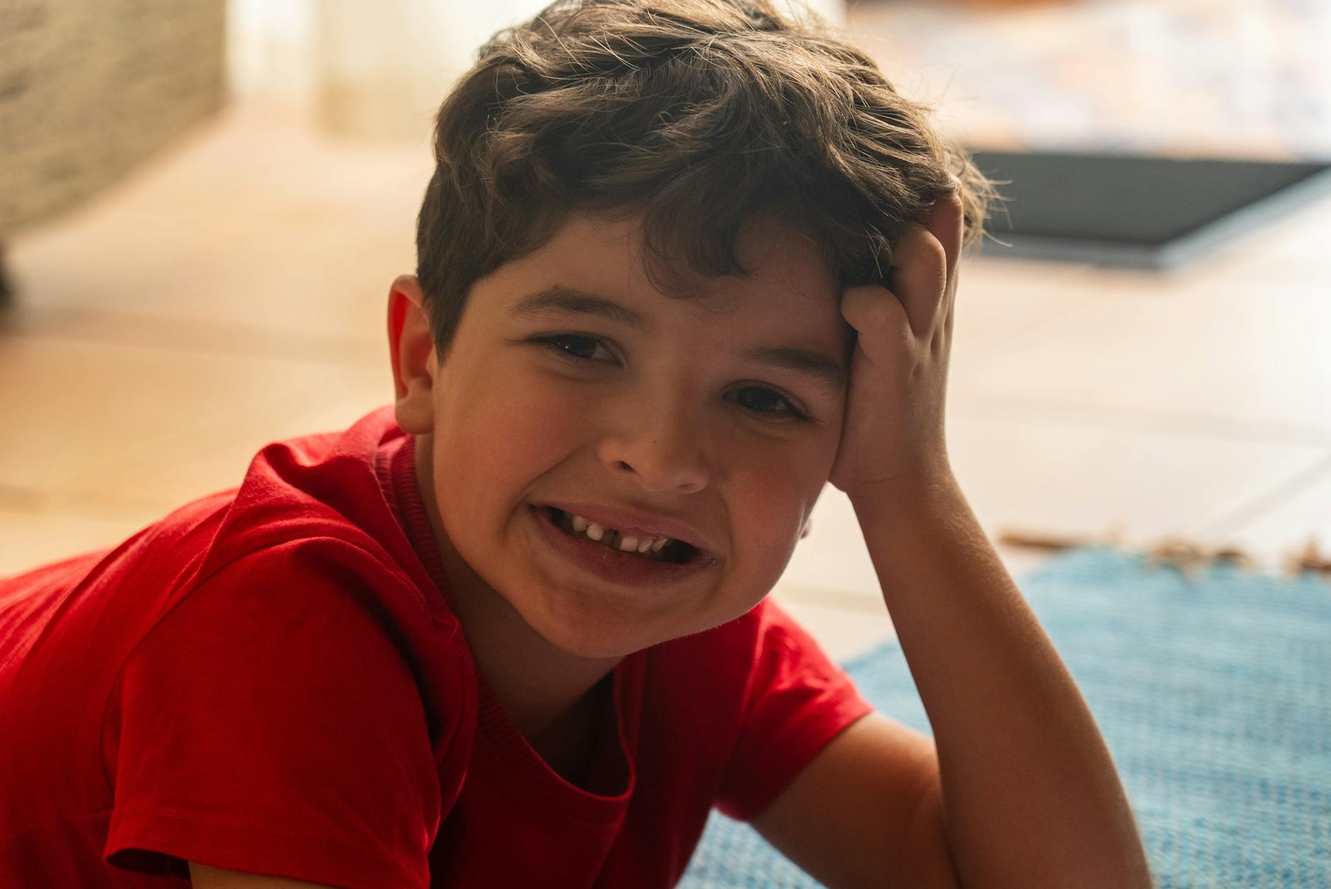 smiling small boy without a front tooth